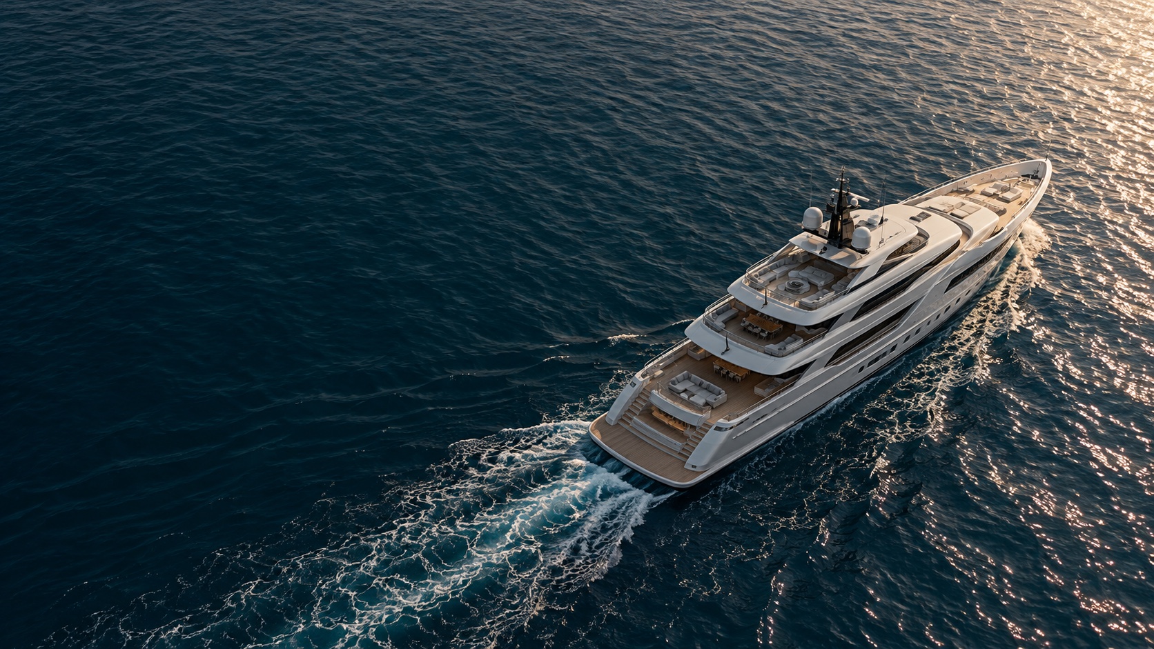 An elegant superyacht moving through deep blue Mediterranean water